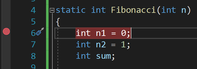 Snímek obrazovky s přerušovacím bodem přidaným v okně editoru Visual Studio.