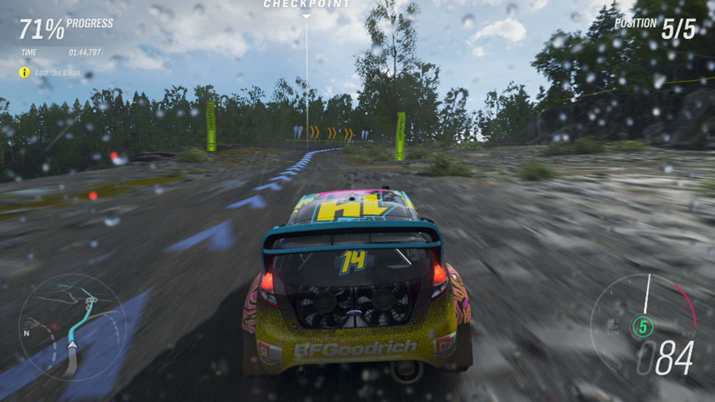 A race car driving on a dirt road in Forza Horizon 4. The mini-map in the lower left has a blue line indicating the path that the player needs to drive, and the speedometer in the bottom right uses red and green to indicate the current gear and high speeds.