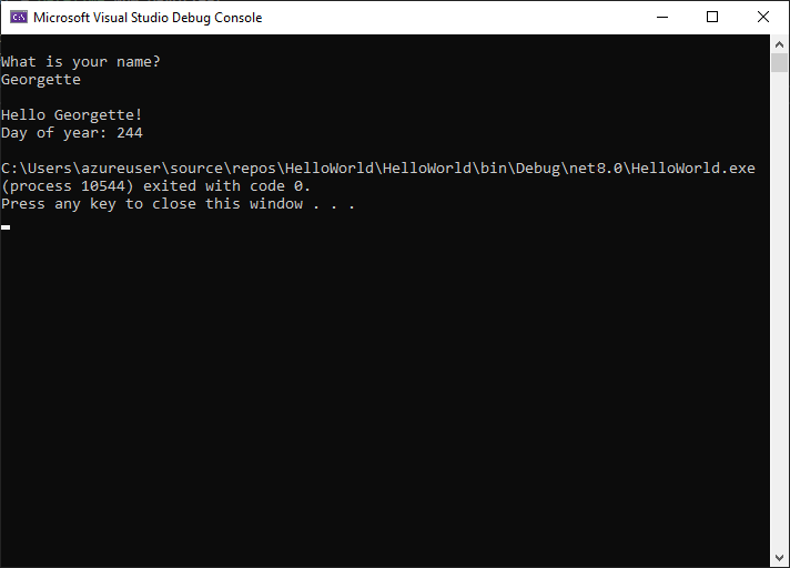 Screenshot: Fenster der Debugging-Konsole mit der Aufforderung zur Eingabe eines Namens, der Eingabe und der Ausgabe „Hello Georgette! Day of year: 244“