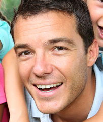Photo of a man who is smiling; this is the same person as the previous image.
