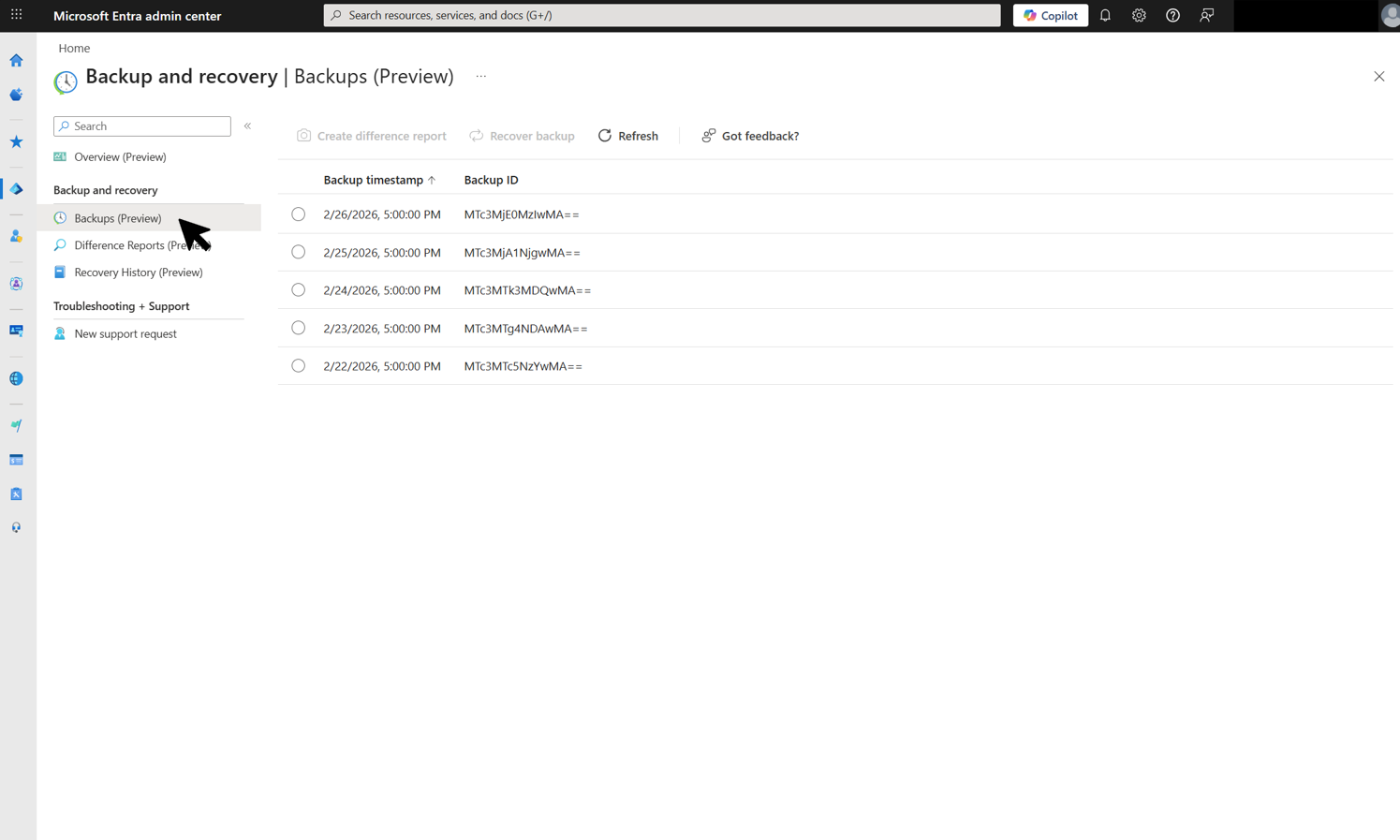 Screenshot of the Backups page showing a list of five available backups with their timestamps and backup IDs.