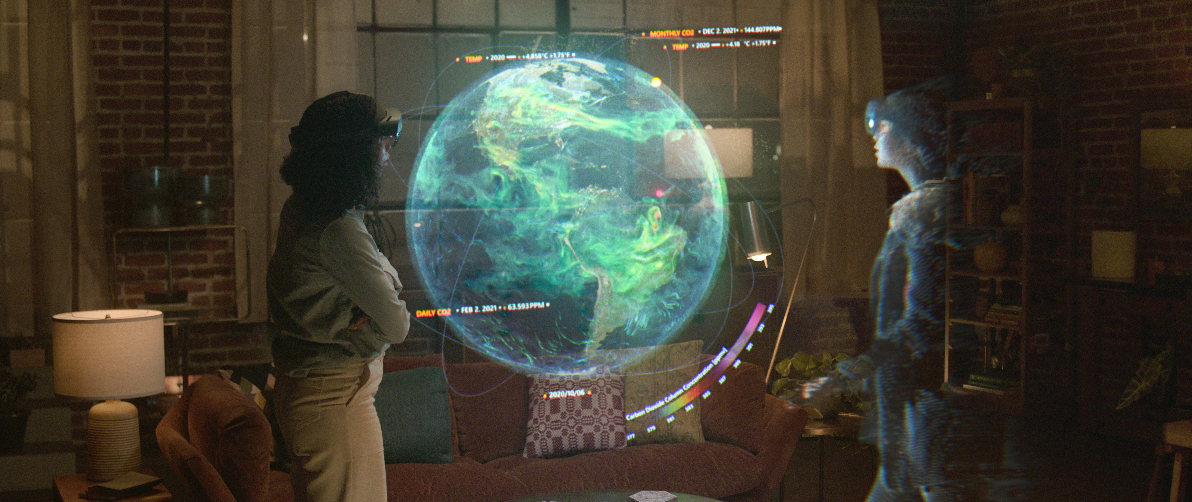 Photo of remote assistance experience of Microsoft Mesh: two people across the globe visualizing 3D holographic image of data as shown on global scale.