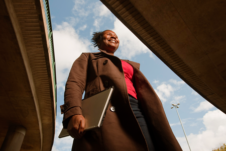 Screenshot of a person walking to work with their laptop.