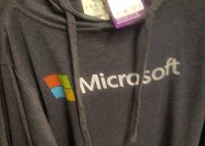 A gray sweatshirt with a Microsoft label and logo on it