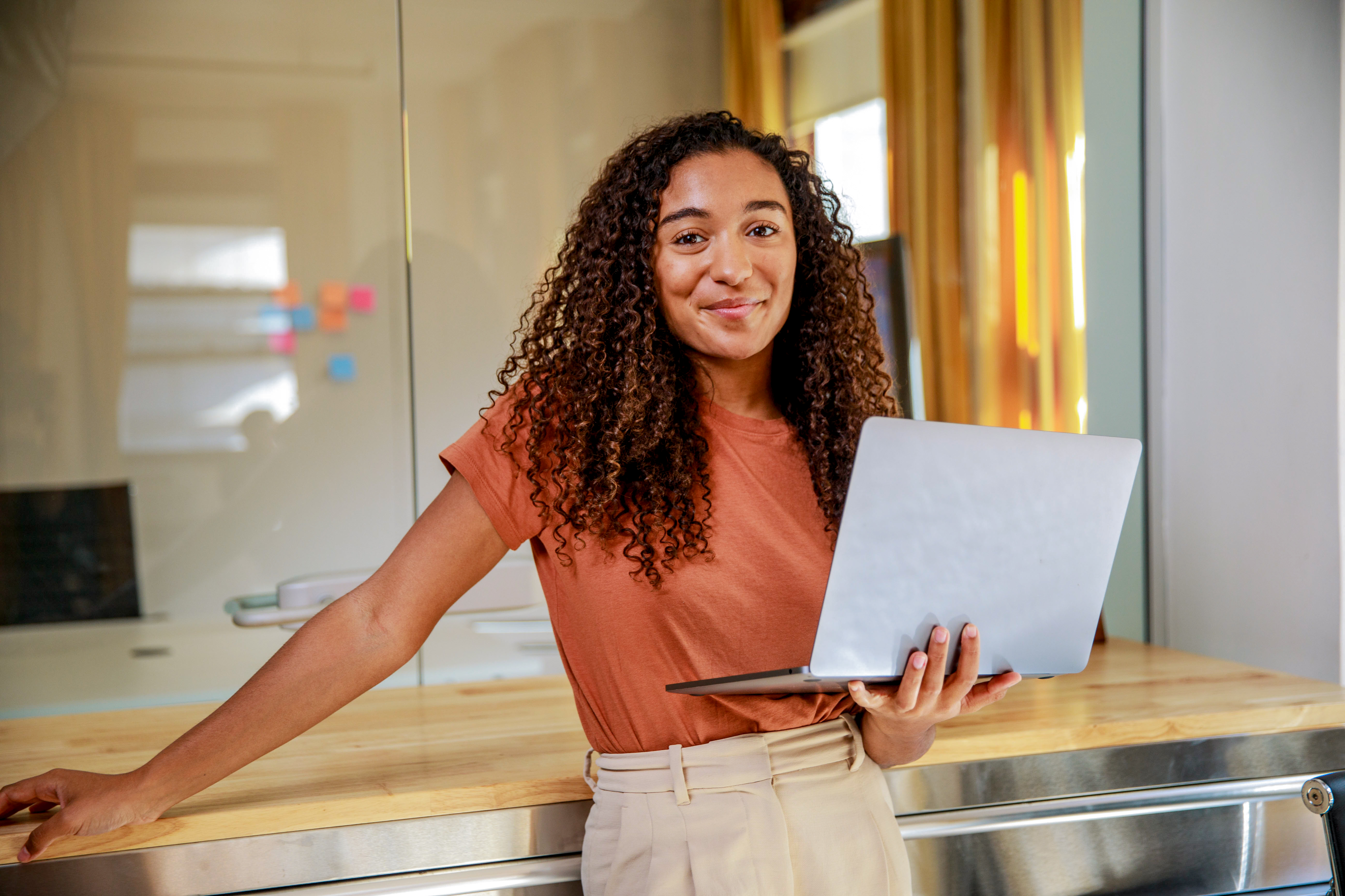 A woman holding a laptop.