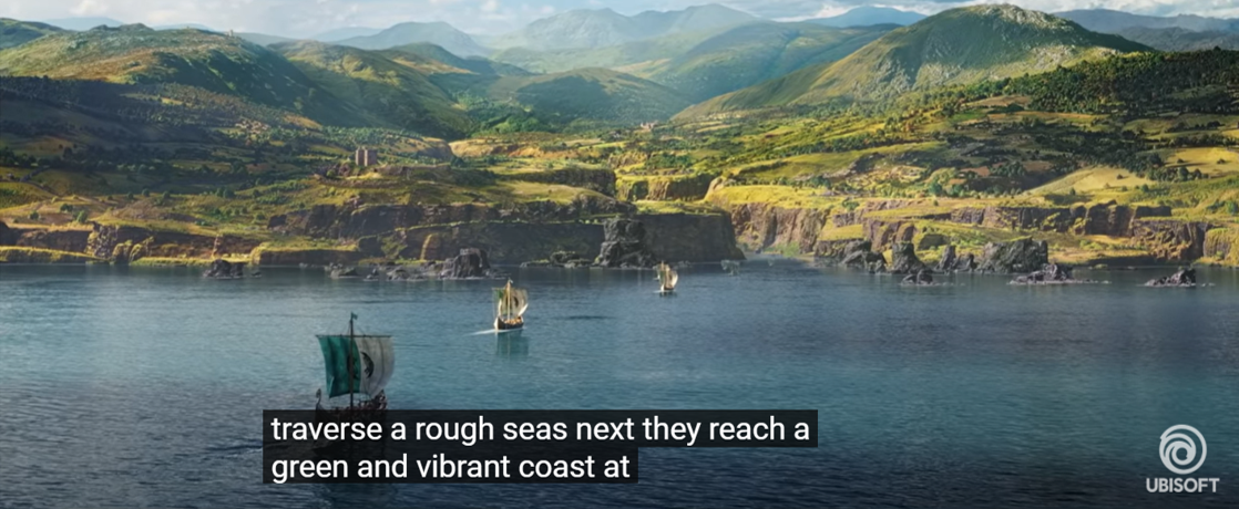 A screenshot from the Audio Described version of the Assassin's Creed Valhalla Cinematic World Premiere trailer. There are three sail boats on a large, turquoise lake. They are sailing toward a large, open mountainous space.