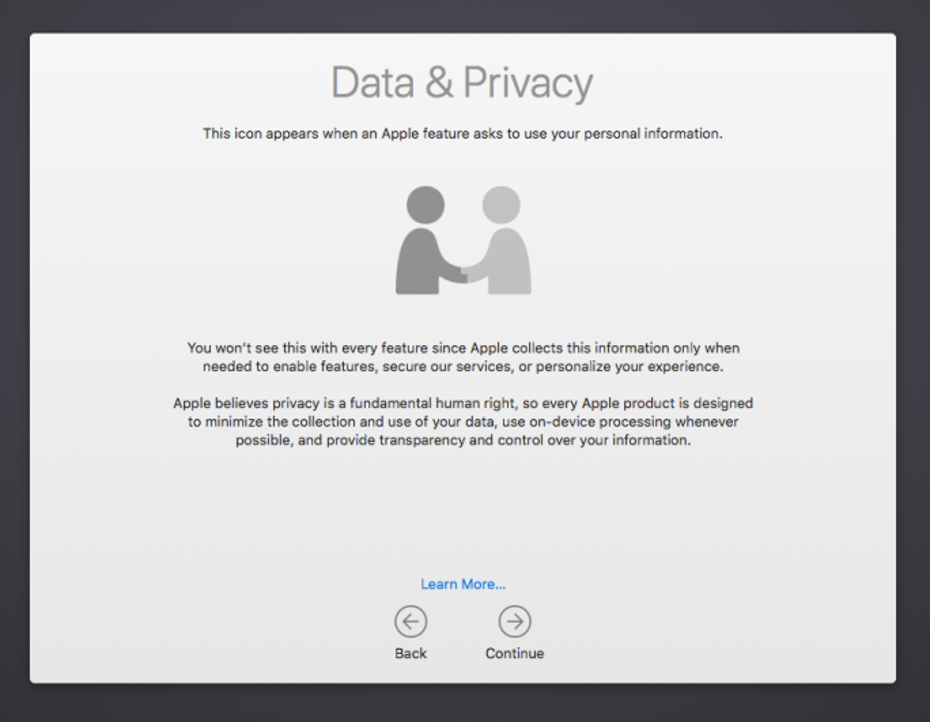 Screenshot of macOS device Setup Assistant Data & Privacy screen, showing an illustration of two people shaking hands, and describing Apple's use of personal information. Also shows a Back and Continue button.