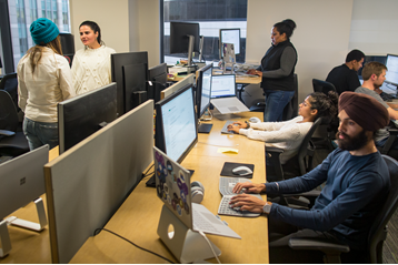 Image of a generic business people in a busy office setting.