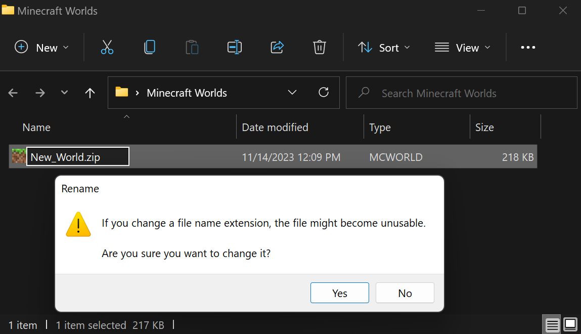 Image showing that the New_World.mcworld file has had the extension renamed to .zip, and the computer is displaying a Rename warning window.