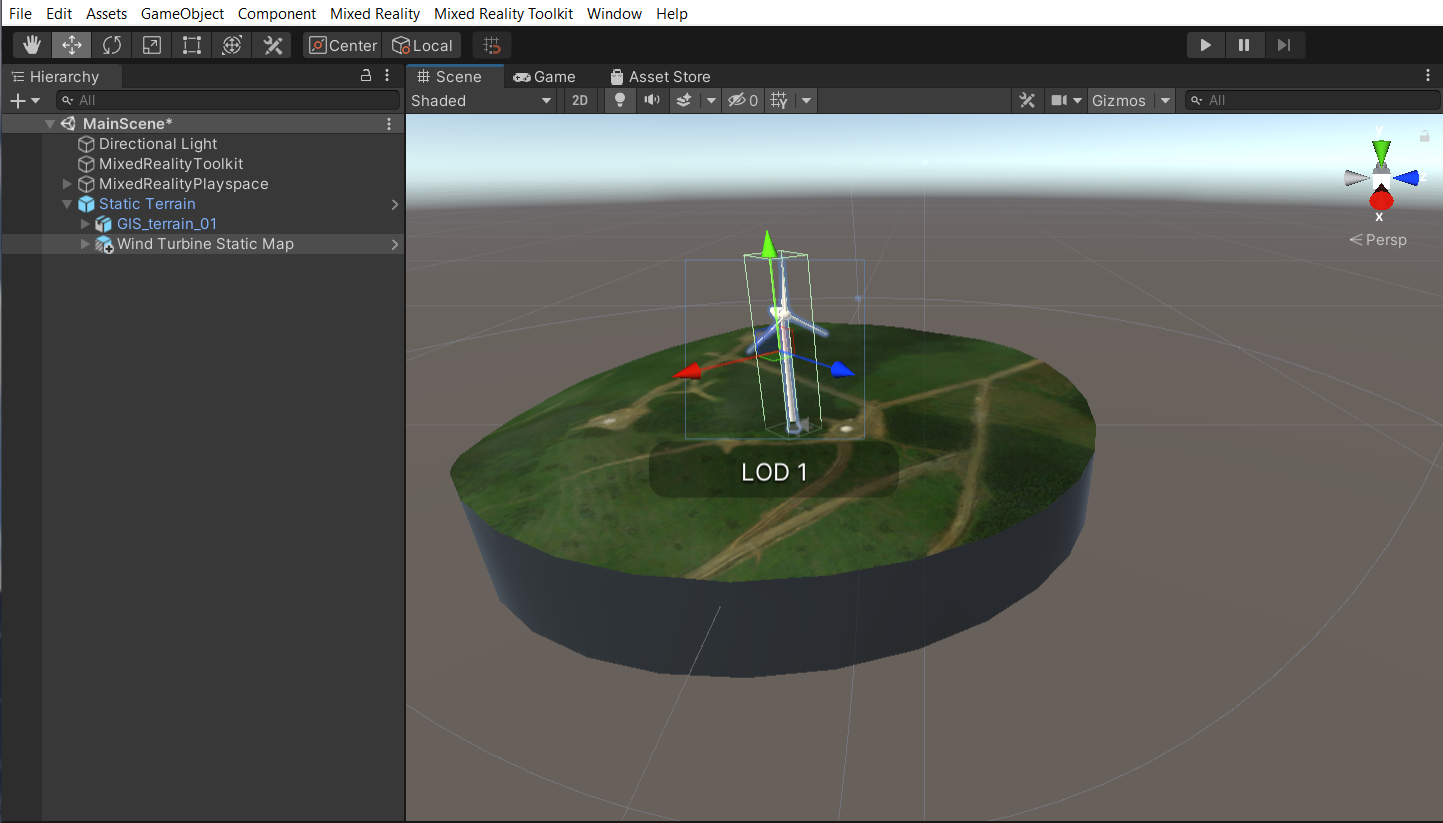 Screenshot of the Unity scene window with the main scene running and the wind turbine static map child object and scale tool highlighted.