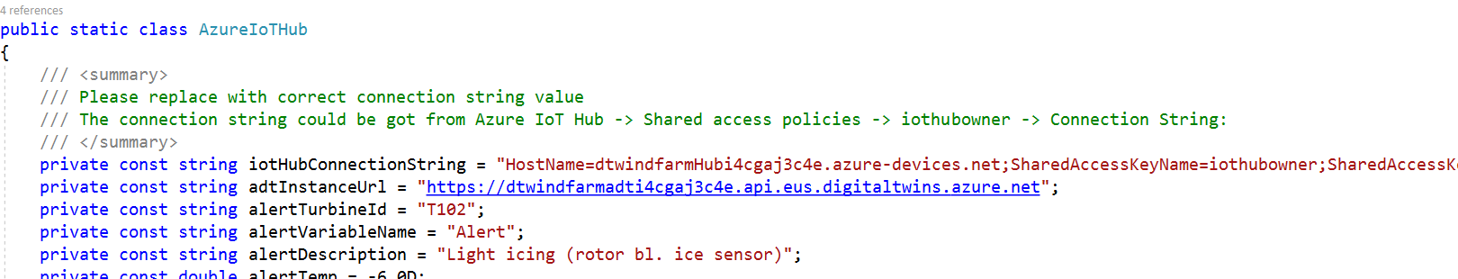 Screenshot of the Device Simulator solution with the Azure IoT Hub cs file open and host name and instance URL values added.