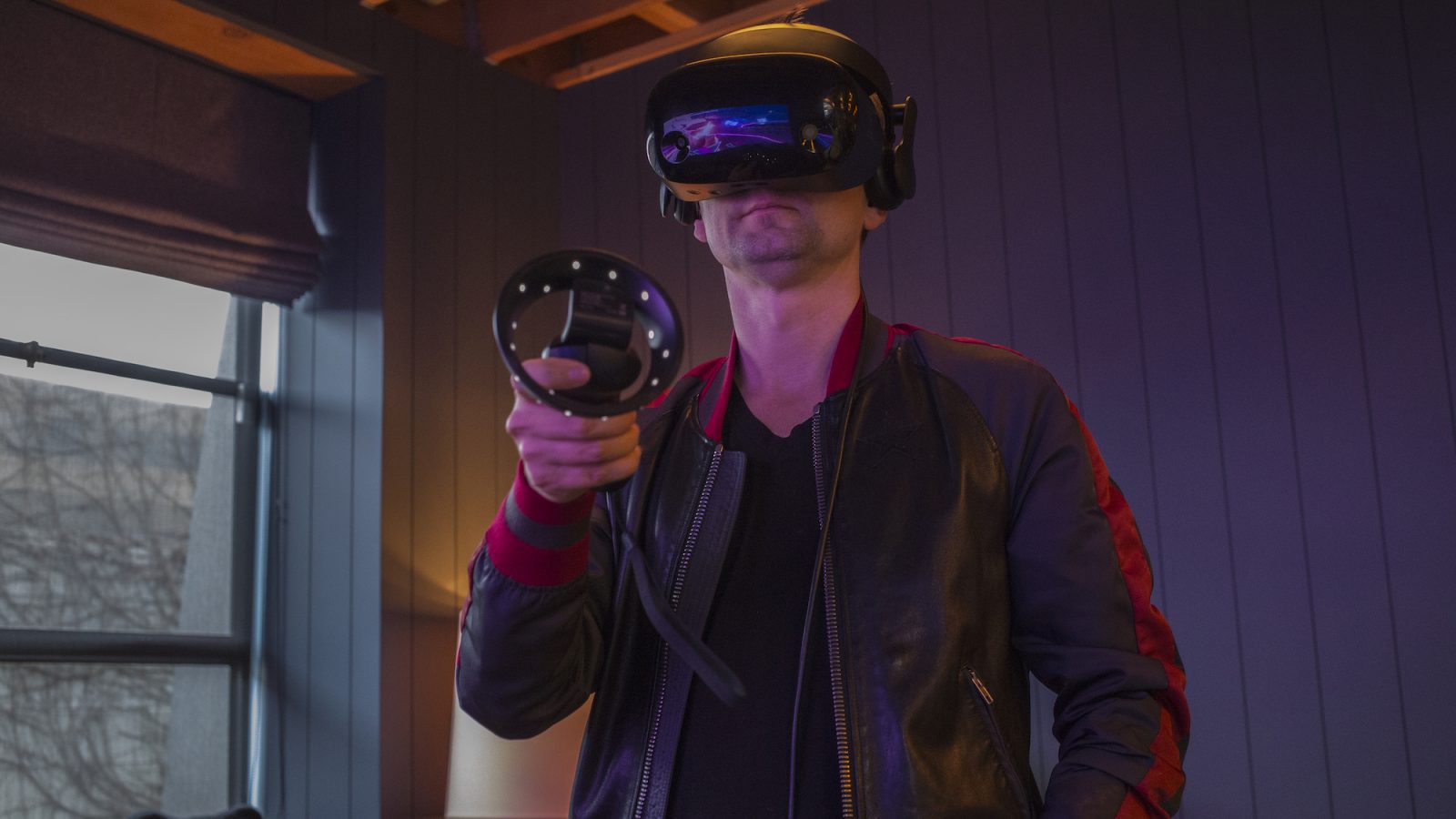Photograph of a user wearing an immersive headset and holding a motion controller.