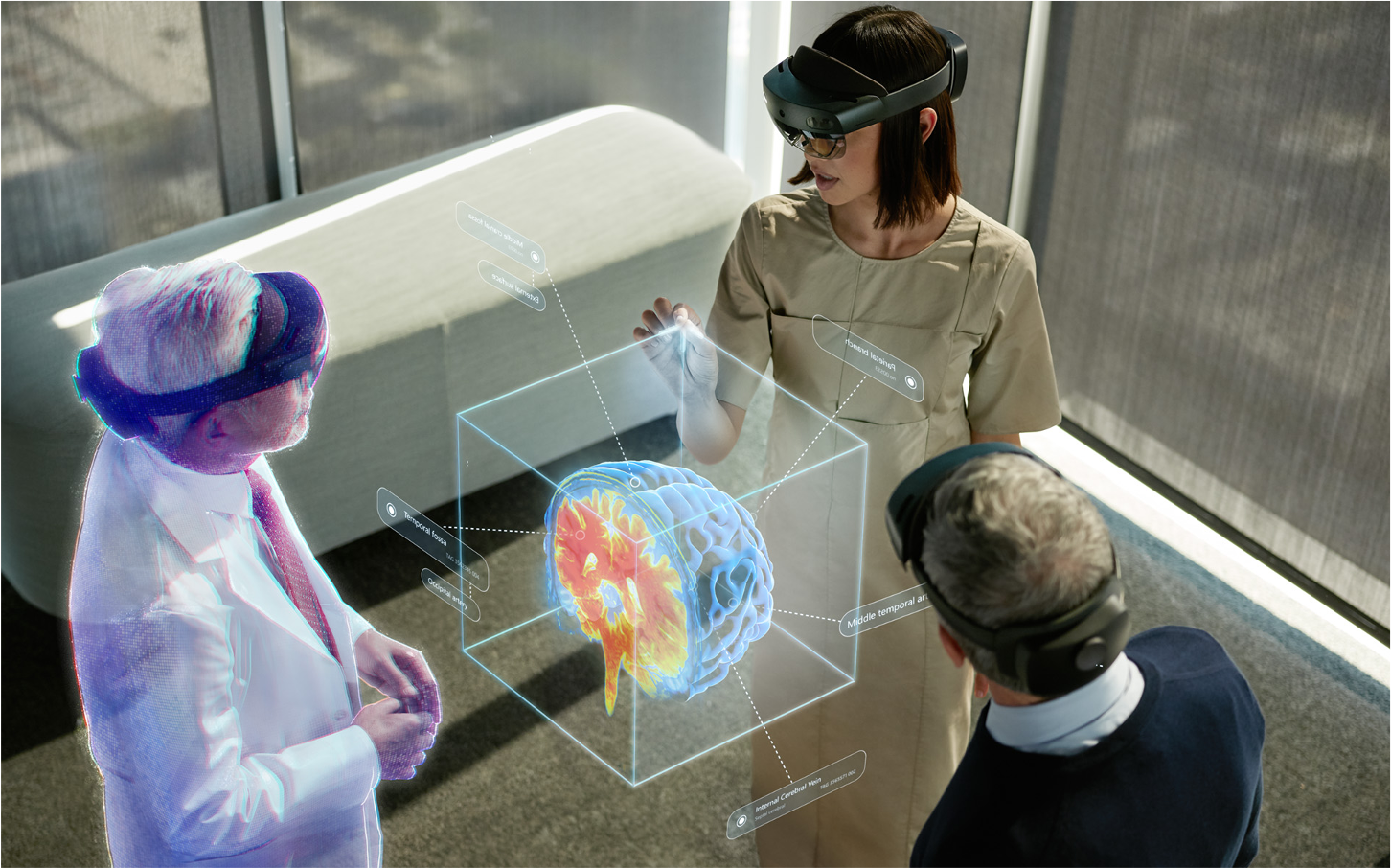 Photograph of people using HoloLens to collaborate.