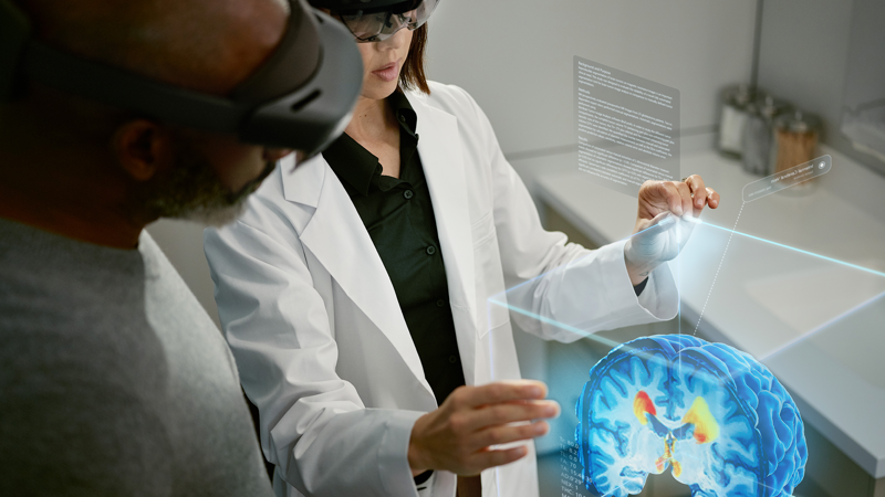 Photo of medical students with a hologram of the human brain.