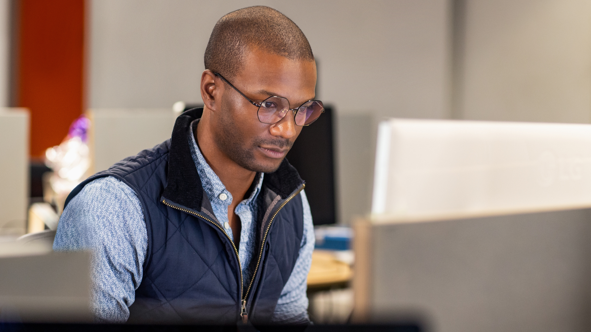 Photo of a software developer at a desk working on a computer.