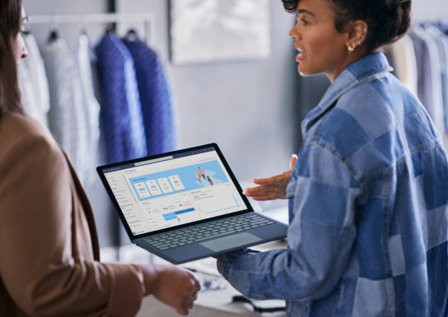 A photograph of retail business manager reviewing real time data with employee.
