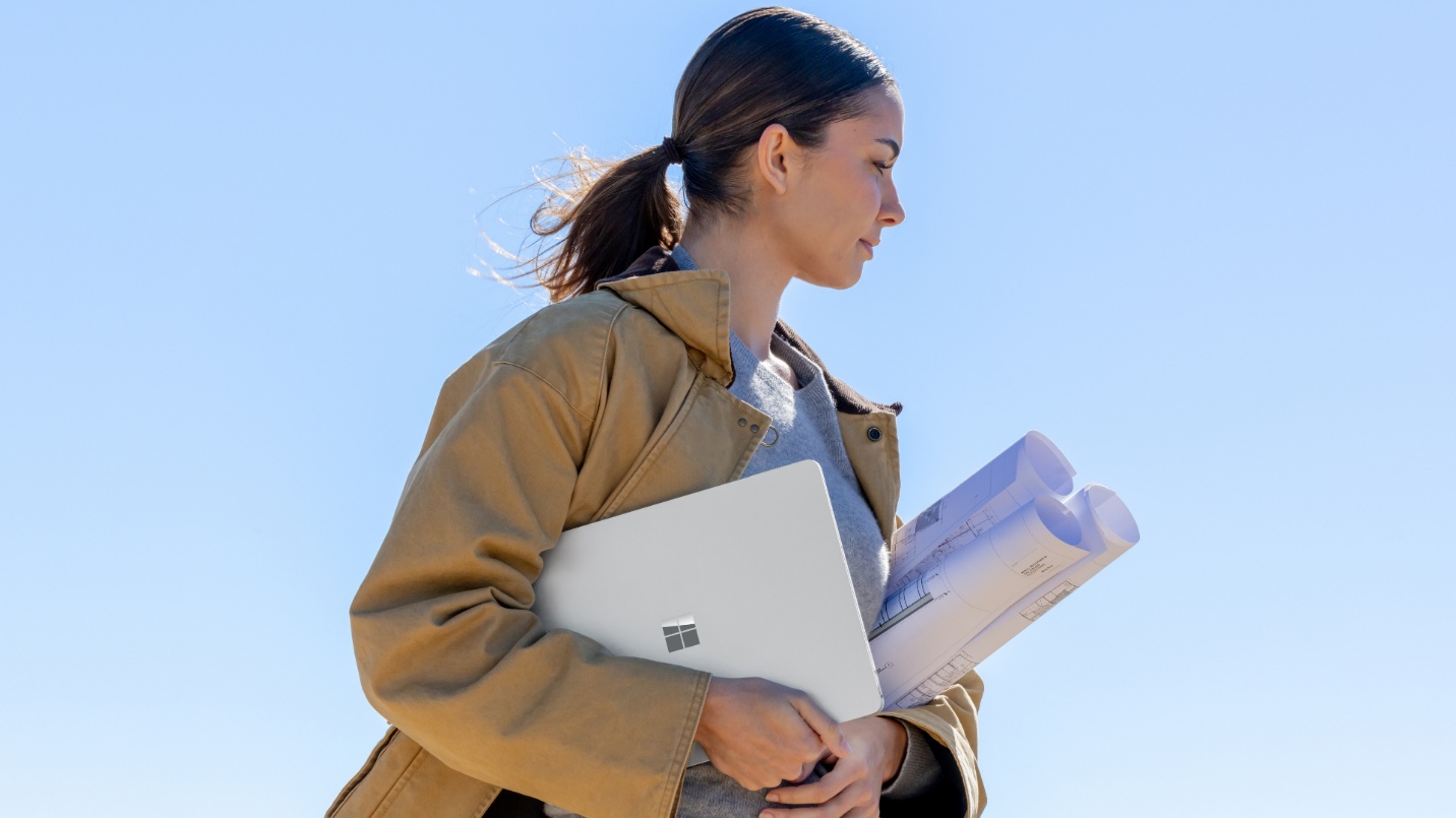 Photo of a mobile professional in the field using a Surface device on the way to an appointment.