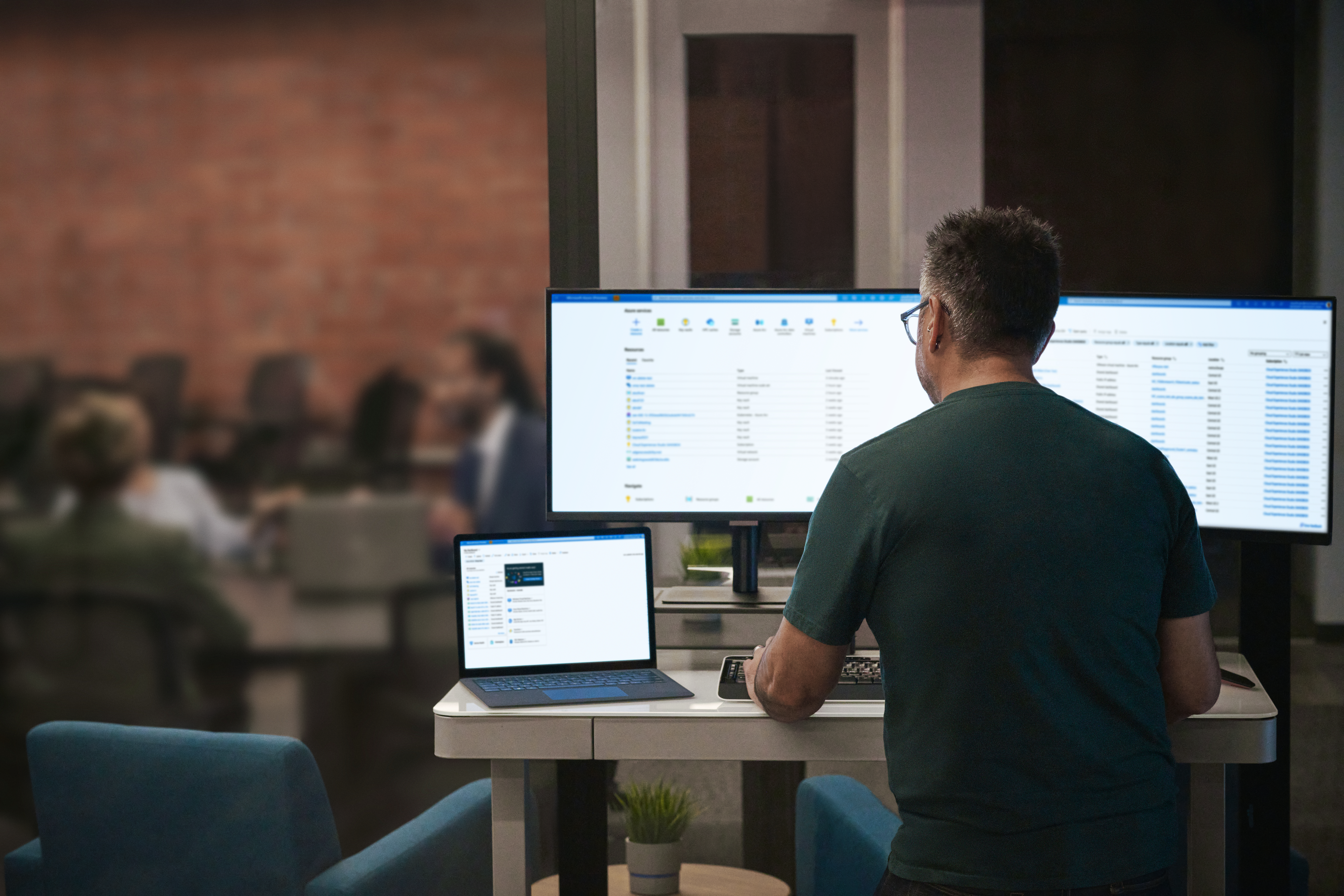 A photograph of an IT professional managing Windows devices across an organization using centralized management tools.