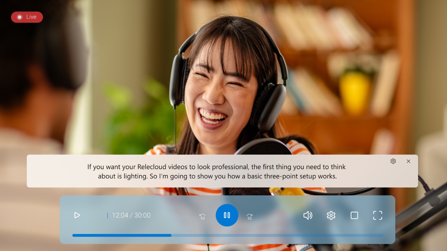 Photo of Live Captions feature being used with a media file playing and the captions displayed on screen.