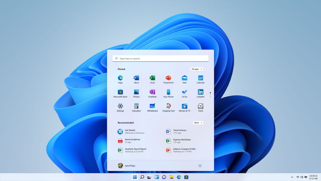 The Windows 11 desktop, with the Start menu opened, showing pinned and recommended apps.