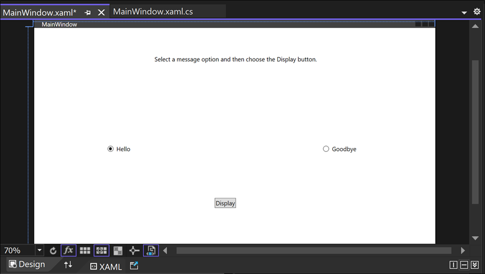 Screenshot of the Design window for Greetings.xaml showing a TextBlock control, two RadioButton controls labeled 'Hello' and 'Goodbye', and a button labeled 'Display'.