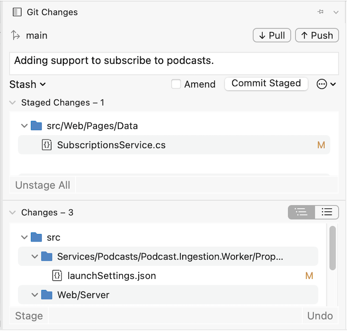 Screenshot of the Git changes dialog, with a launchSettings.json file in the list of Changes, and a SubscriptionService.cs file in the list of staged changes. The current branch name is shown at the top of the window, along with Push, Pull, and Commit Staged buttons.