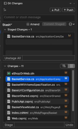 The Visual Studio for Mac Git Changes window, open showing a list of files in a Changes list. A BasketService.cs file is in a Staged changes list.