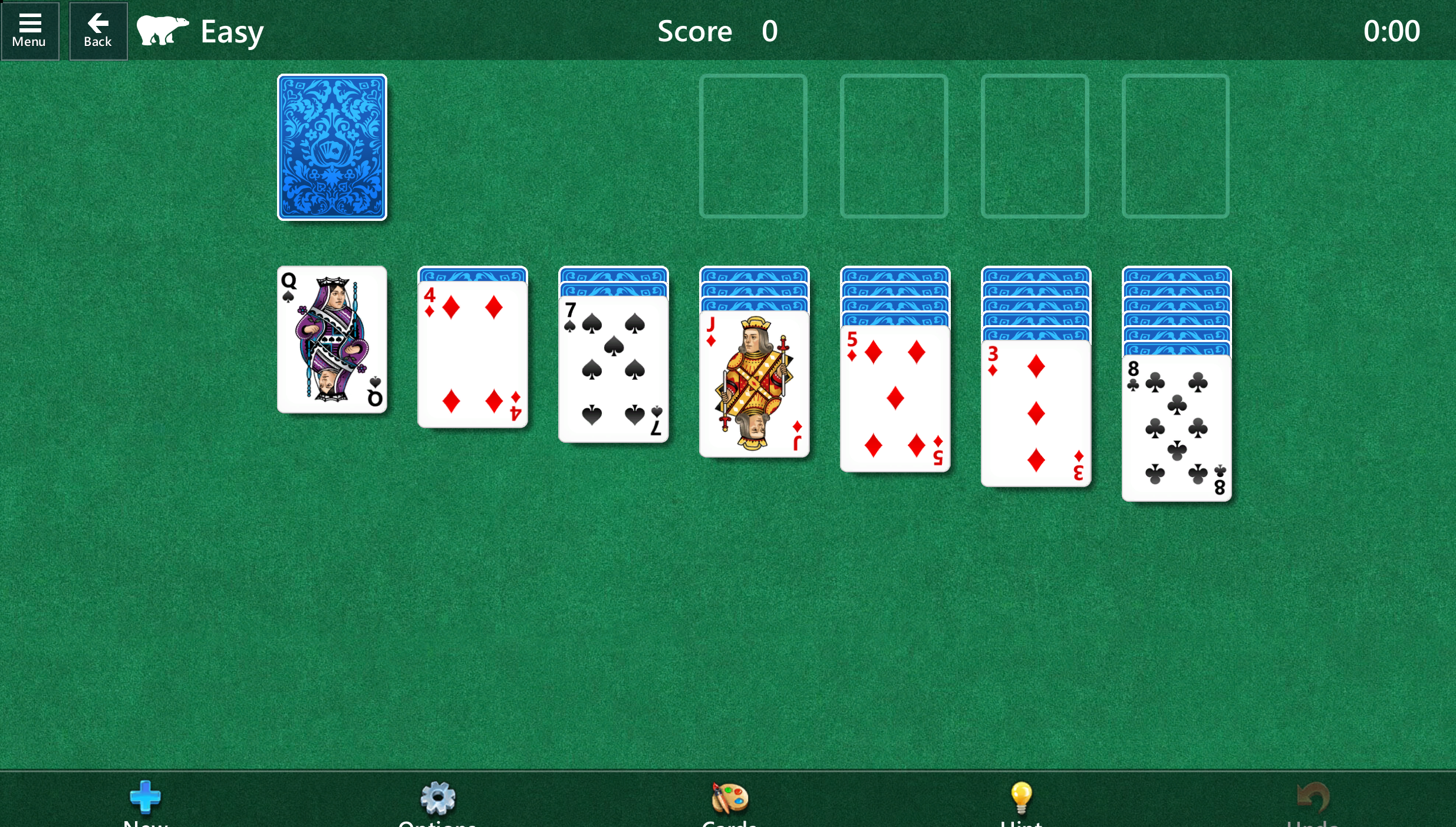 Standard solitaire game mode. White cards are laid out on a green table. The back of the cards show an intricate leafy green pattern.