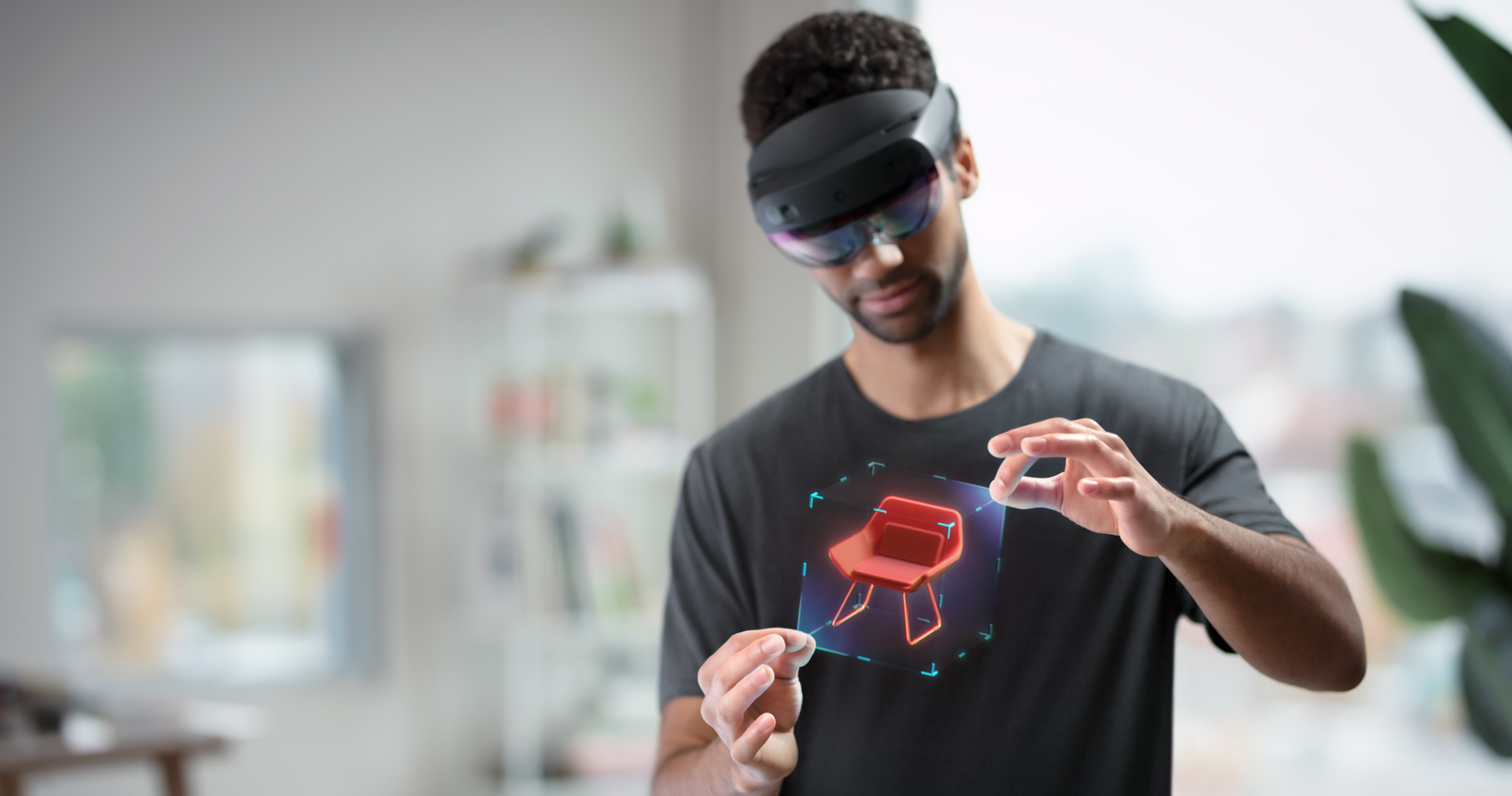 Image d’un utilisateur portant un HoloLens et manipulant un hologramme avec le mouvement de la main