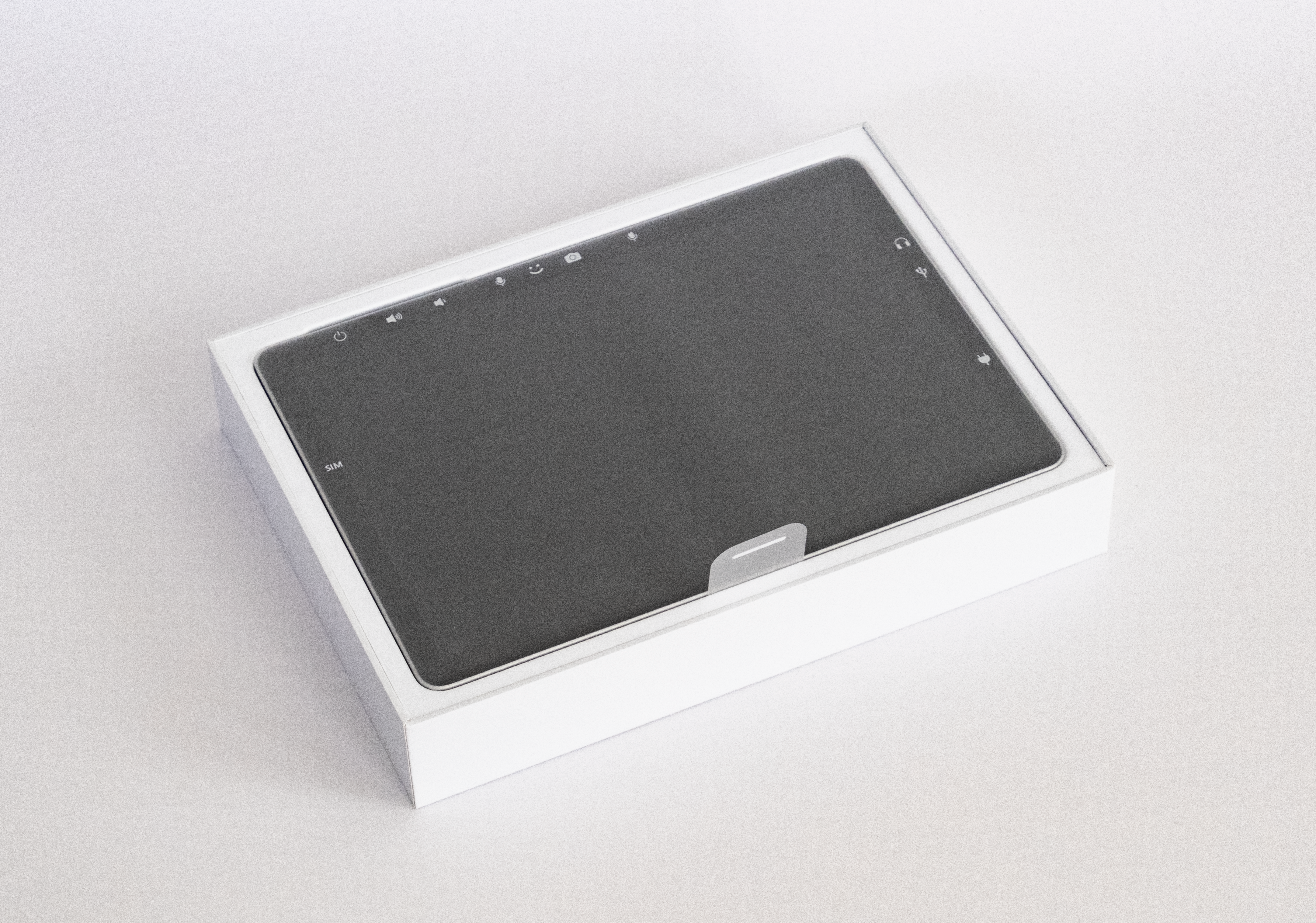 An image of the packaging for a Microsoft Surface device. A pull tab to remove the device is visible. 