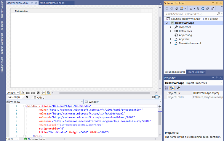 Screenshot of the HelloWPFApp project and solution in the Visual Studio IDE with the Solution Explorer open, and the XAML and designer views of 'MainWindow.xaml' open in the WPF Designer. WPF project and solution in the IDE