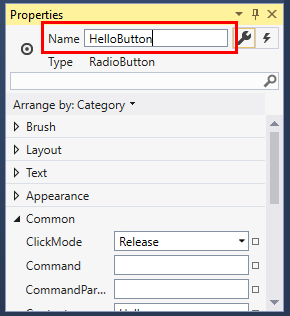 Screenshot of the Properties window for a RadioButton control. The value of the Name property has been changed to 'HelloButton'. RadioButton properties window