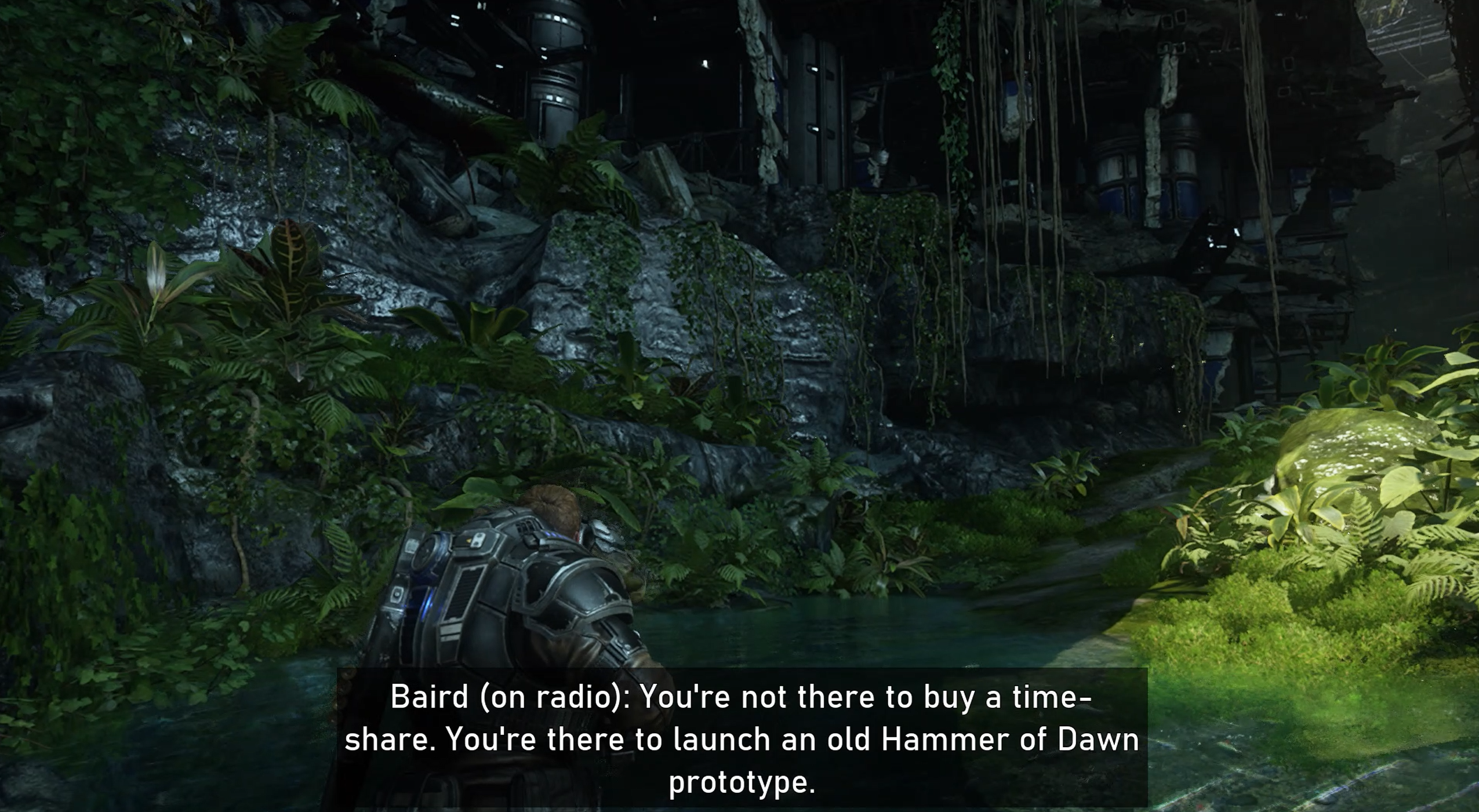 Gears 5 gameplay. The player is in the forest. The subtitles at the bottom of the screen says, "Baird (on radio): You're not there to buy a timeshare. You're there to launch an old Hammer of Dawn prototype." 