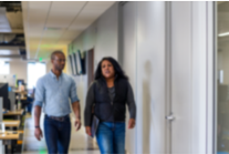 Photo of people walking, with motion blur.