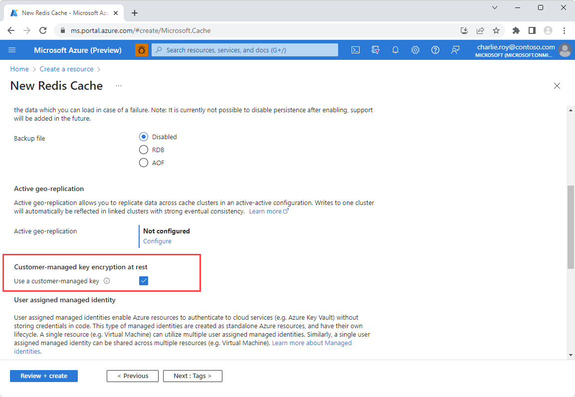 Screenshot of the Advanced settings page with the customer-managed key encryption at rest option enabled and highlighted in a red box.