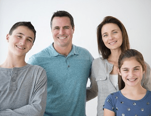 Four people posed together as a family