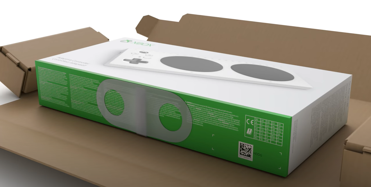 Uma imagem do empacotamento do Controlador Adaptável do Xbox com um grande adesivo que sela a caixa.