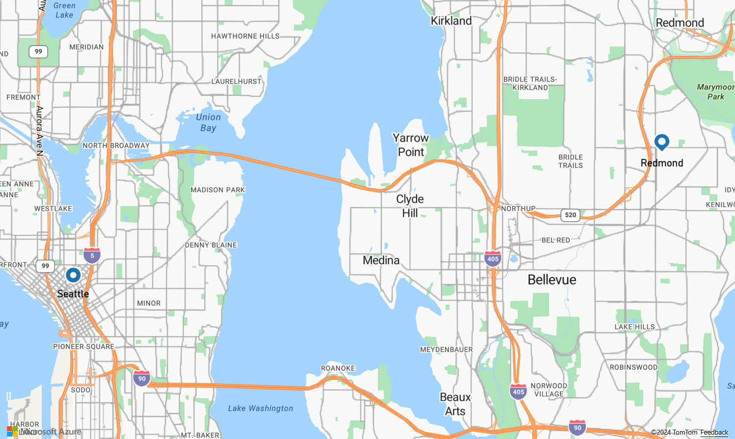 Uma captura de tela mostrando um mapa com uma rota contendo um pino de lágrima azul marcando o ponto de partida na Microsoft em Redmond Washington e um pino redondo azul marcando o ponto final em um posto de gasolina em Seattle.