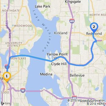 A map with Road imagery that displays a route between Seattle and Redmond in Washington state. Also shows custom icons 64 and 66 that display as endpoints with the numbers 1 and 2.