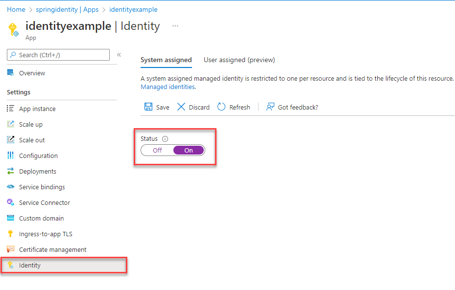 Screenshot of Azure portal Identity page of App resource with System assigned tab showing and Status field highlighted.