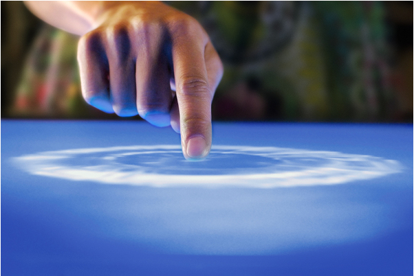 photo of finger on touch screen showing ripples