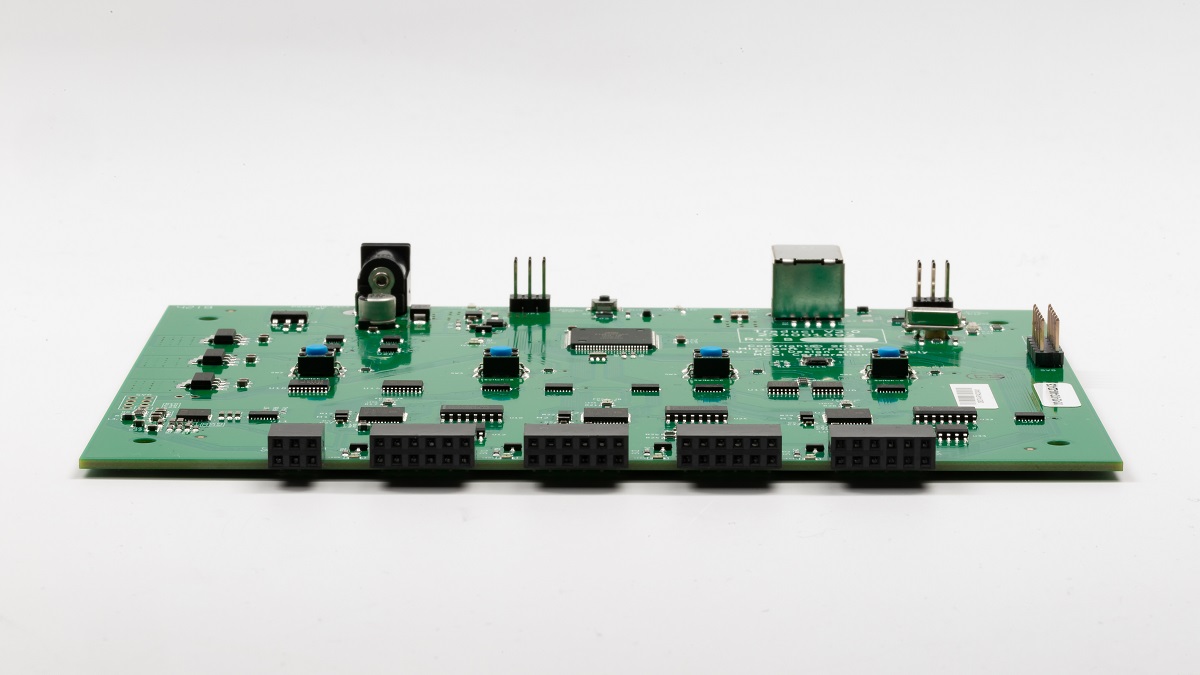 Photo of a Traduci circuit board with four 12-pin ports labeled JA, JB, JC, and JD.